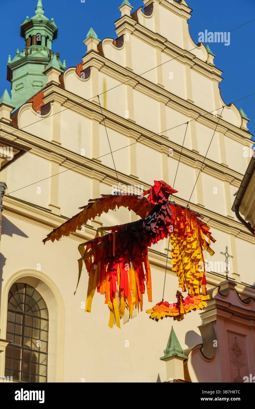 Lublin, popular travel destination in Poland. Dominican renaissance monastery and street art color birds flying over Zlota street on a sunny day Stock Photo
