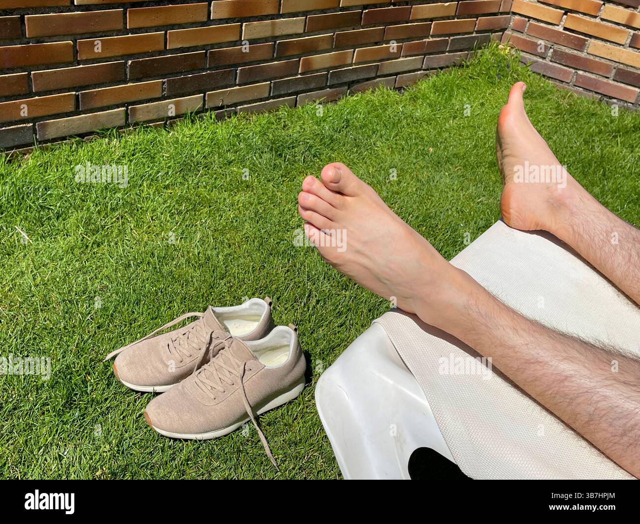 Barefoot man resting in a hammock. - Smartphone Captured Stock Image