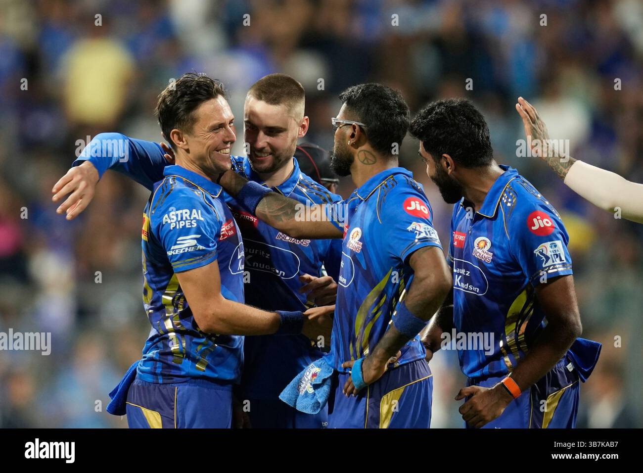 Mumbai Indians' Trent Boult, left, celebrates the wicket of Gujarat ...