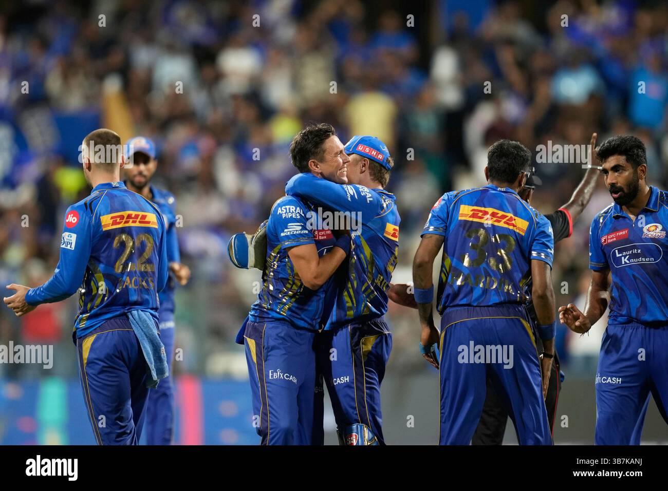Mumbai Indians' Trent Boult, center left, celebrates the wicket of ...