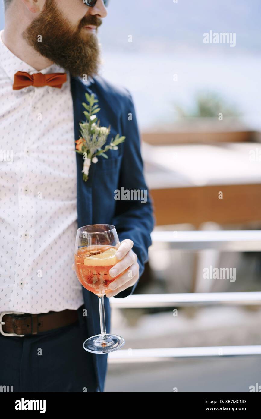 Bearded redhead groom with a glass in his hand. Stock Photo