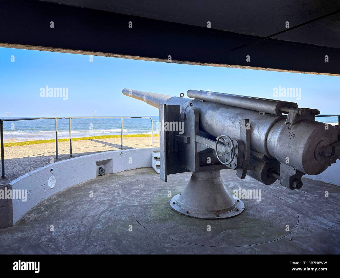 replica 6 inch gun at the Blyth world war 2 sea defences looking out to sea at Blyth South Beach, Northumberland, UK - Smartphone Captured Stock Image