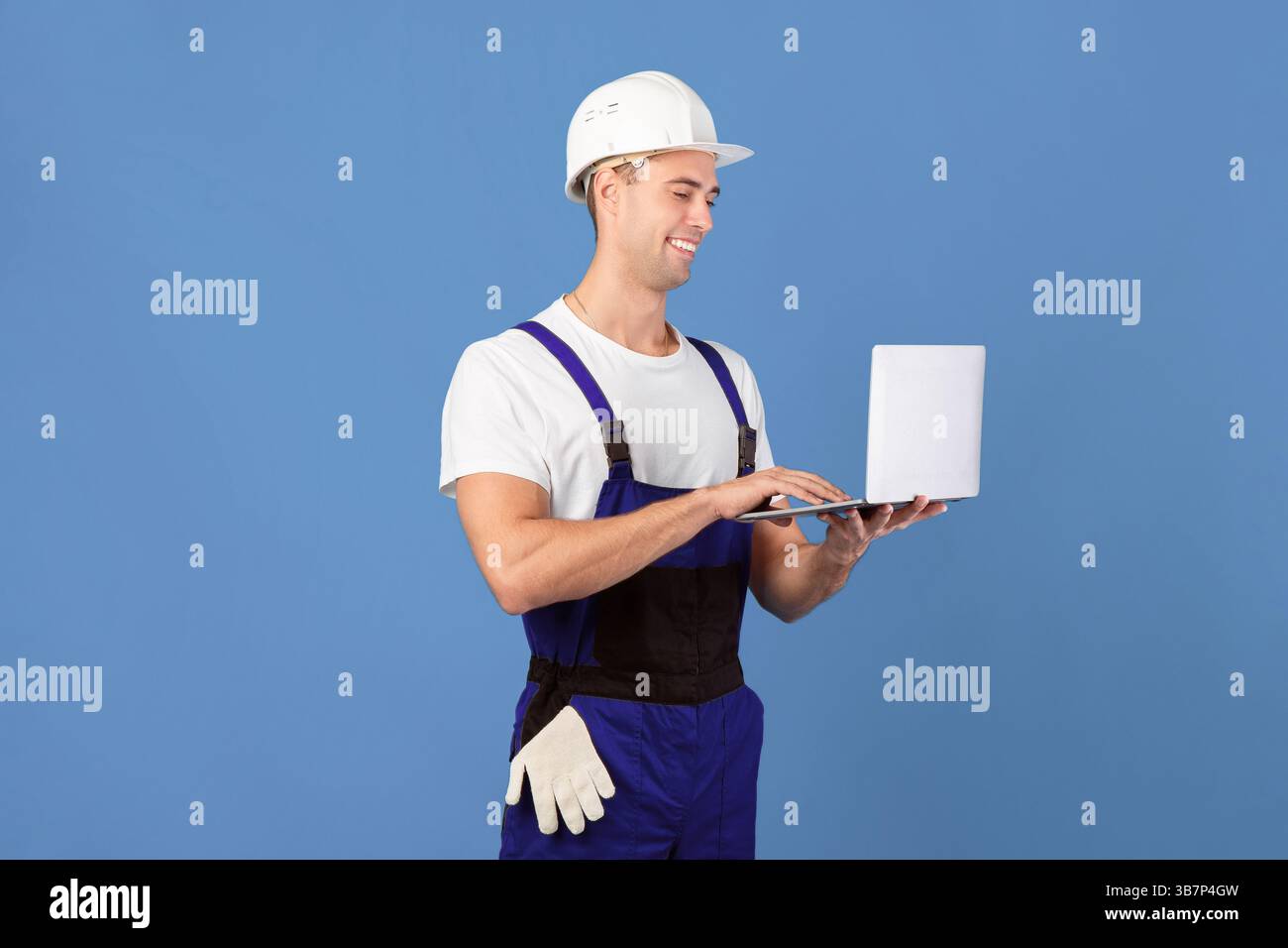 Handsome Young Foreman Guy With Laptop, Ordering Construction Materials Online Stock Photo