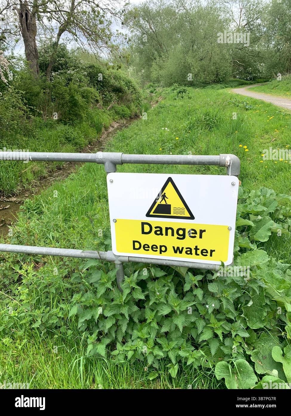 Danger sign signs flood risk area caution deep water wet and muddy ...