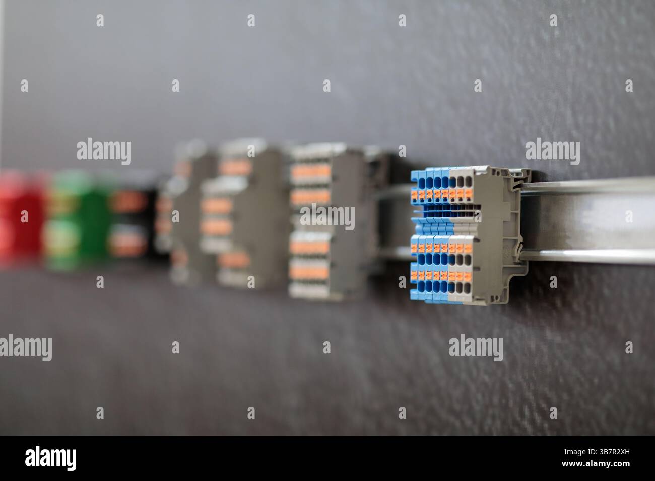 Different types of terminal blocks mounted on DIN rail close up ...