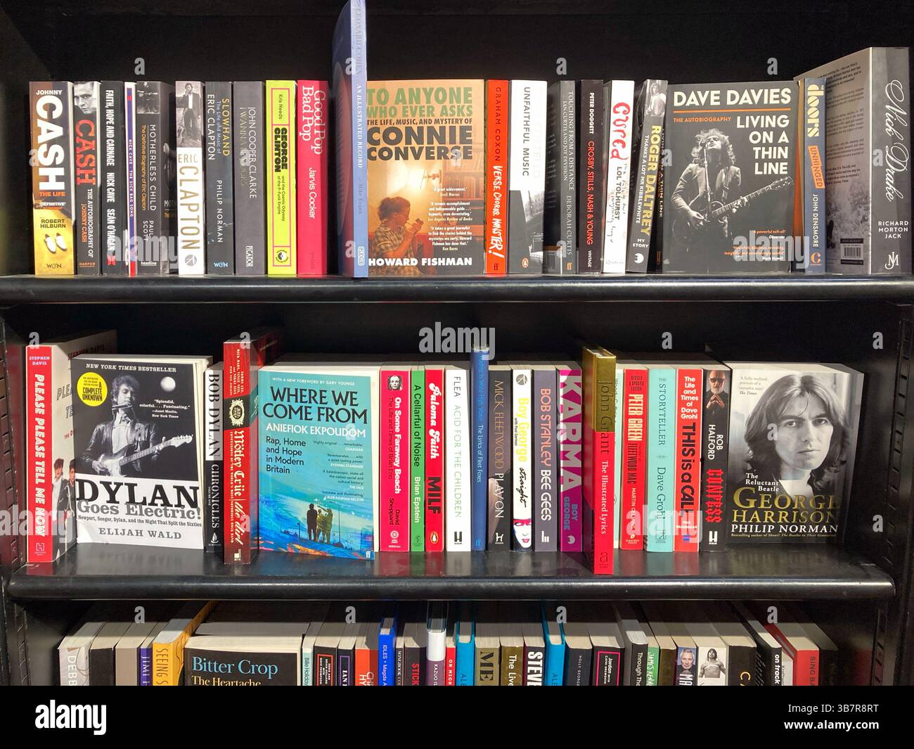Paperback books of famous rock and roll bands and pop stars for sale at the book store Stock Photo
