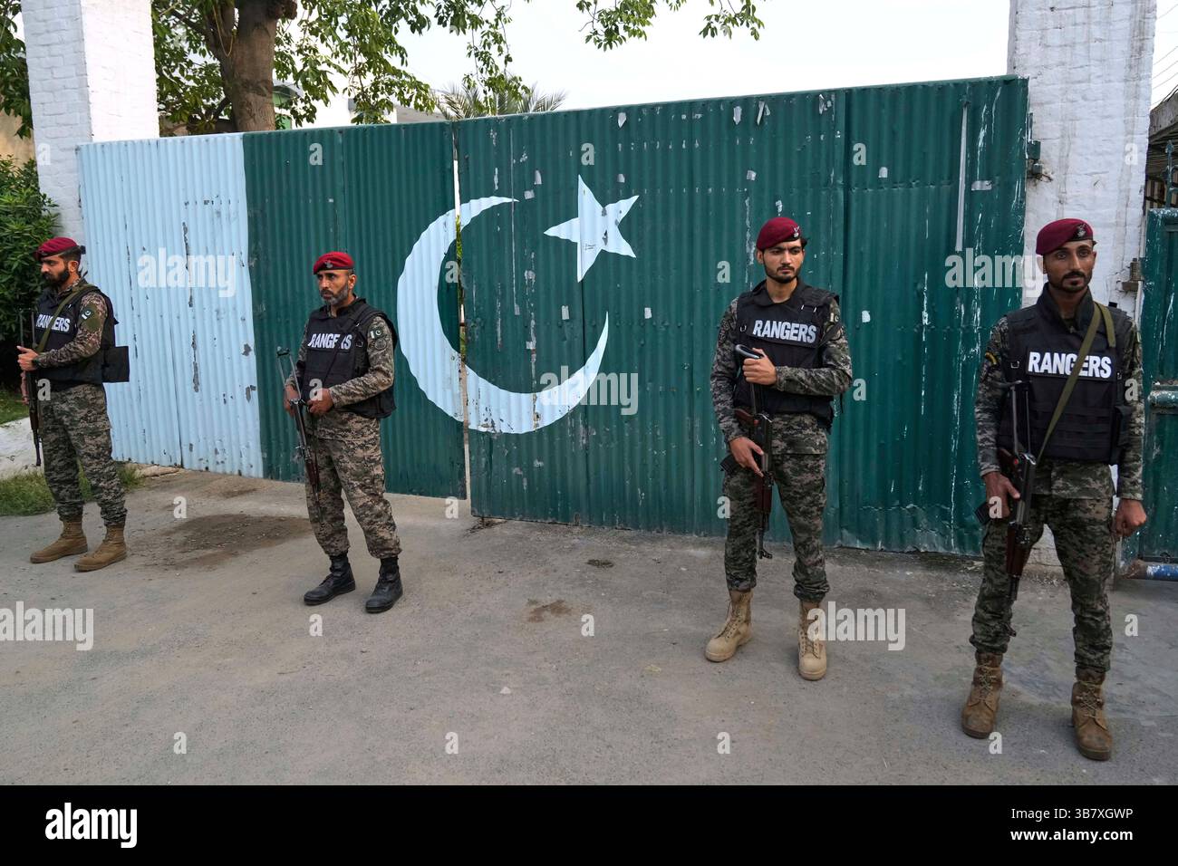 Pakistani paramilitary stand guard outside a gate of a complex close to ...