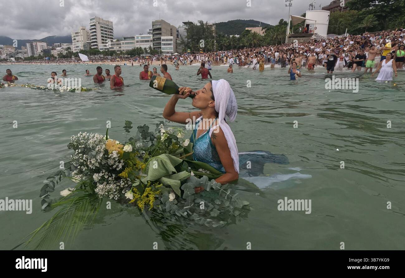 February 2, 2024, Rio De Janeiro, Rio De Janeiro, Brazil: Thousands of practitioners of the Afro-Brazilian Umbanda faith and supporters met on Ipanema Beach in Rio de Janeiro to make offerings during the annual February 2 celebration of Iemanja, praying for more blessings in the coming year. The Goddess of the Sea unites believers in a celebration of devotion, prayers, and the deep connection between land and ocean. During the time of slavery, the Yoruba people introduced Iemanja worship to Brazil. (Credit Image: © Bob Karp/ZUMA Press Wire) Stock Photo