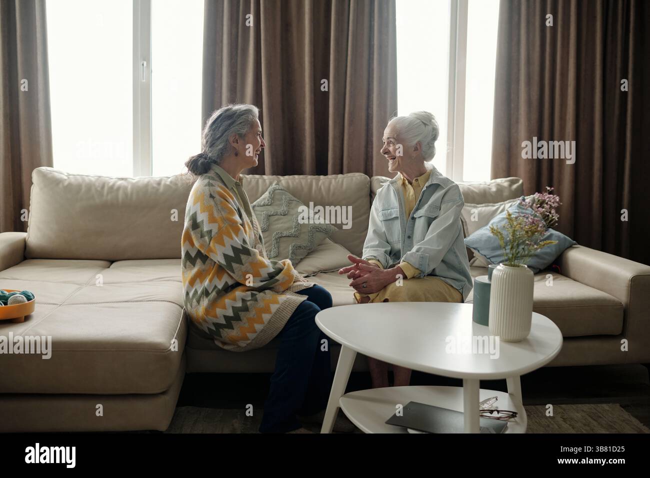 Two Elderly Women Having a Friendly Conversation Stock Photo