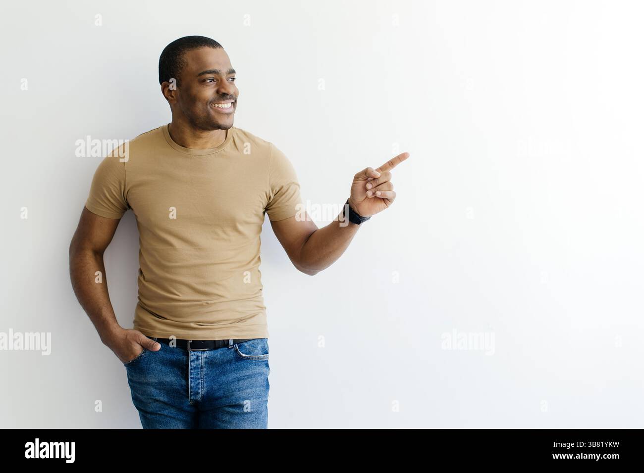 Look There. Young Black Man Pointing Aside At Copy Space With Finger Stock Photo