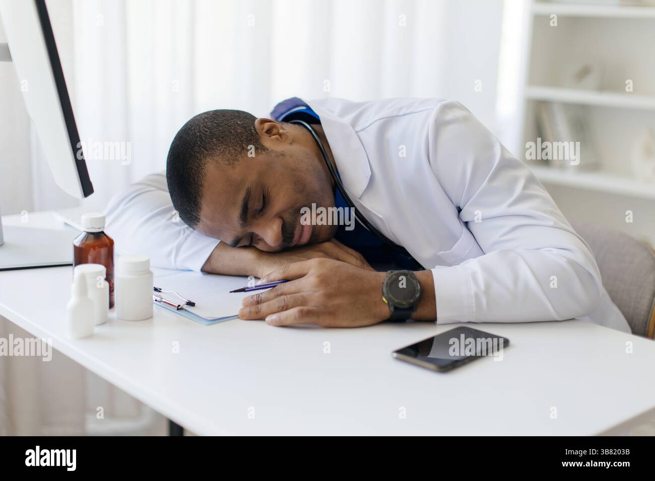 African doctor sleeping sitting in hi-res stock photography and images ...