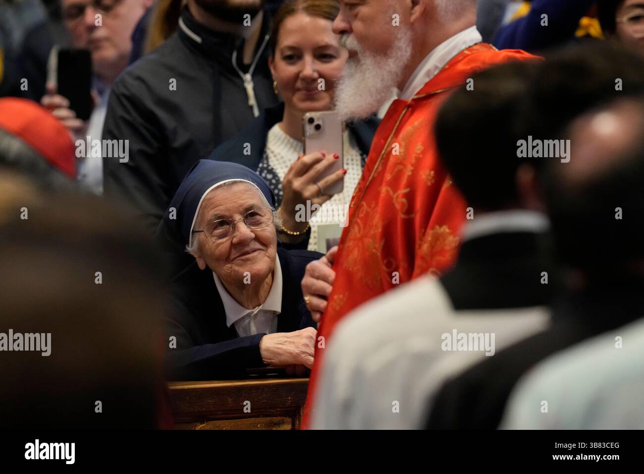 A nun looks at Cardinal Dominique Joseph Mathieu walk past during a ...