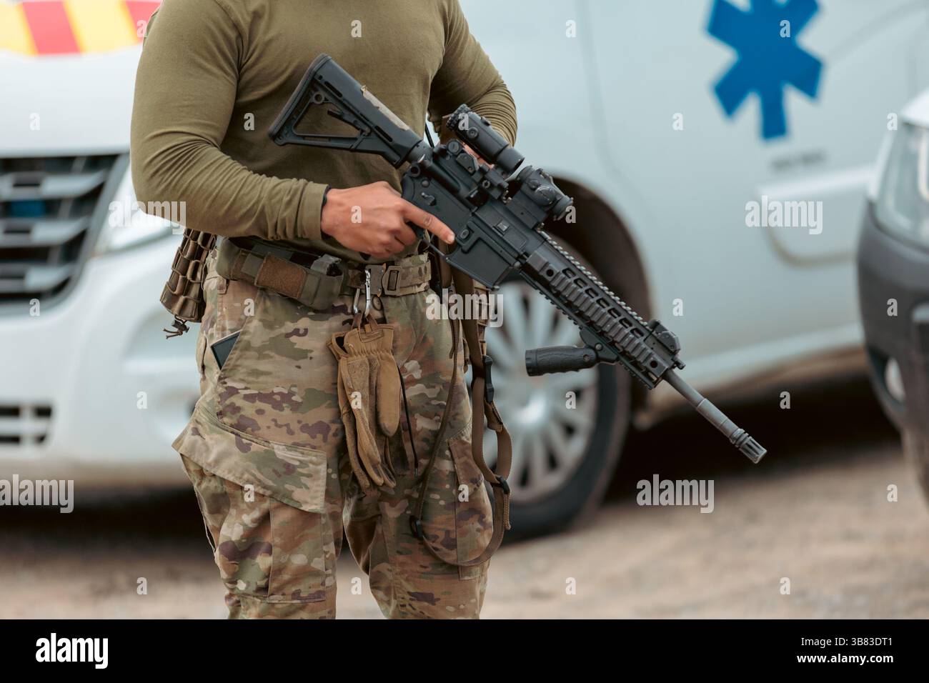 Soldier of Ukraine with assault rifle and flag of Ukraine on military ...
