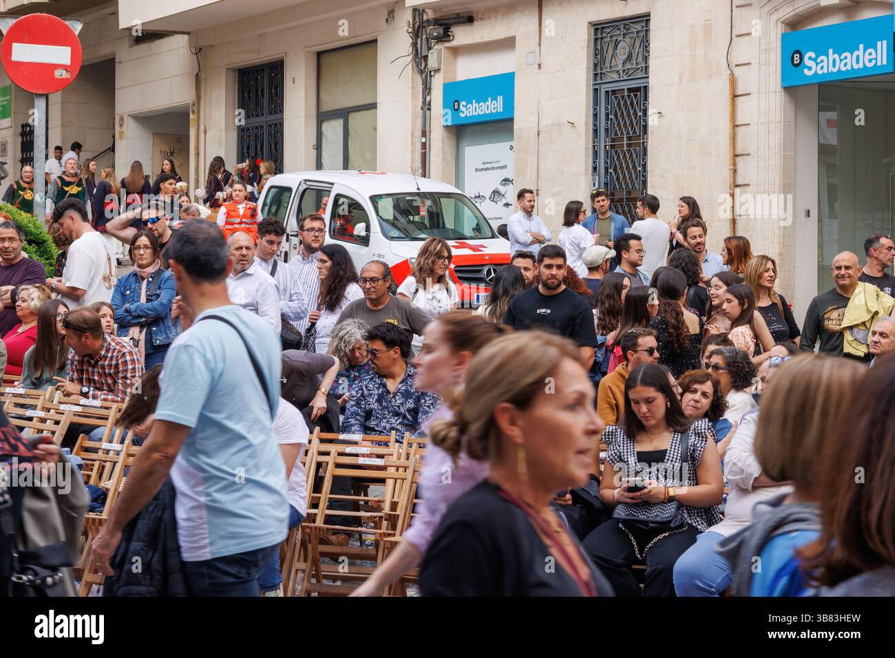 Alcoy, Spain, 05-03-2025: Red Cross ambulance among the crowd as a precautionary measure during the 2025 Alcoy Moors and Christians parade Stock Photo
