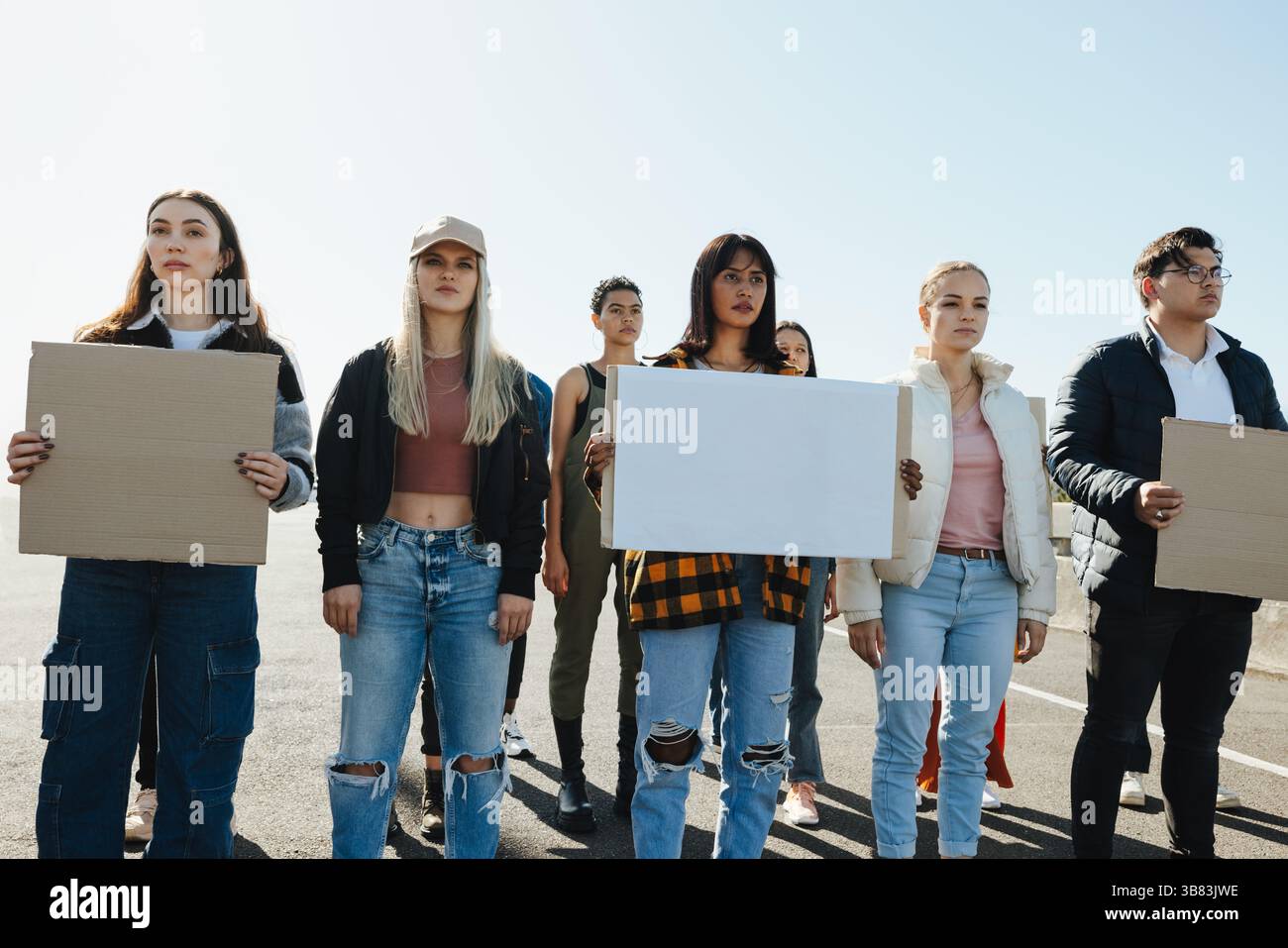 A diverse group of individuals displaying unity and activism by holding ...