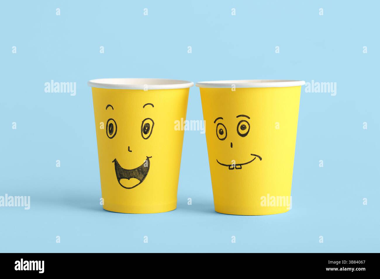 Funny paper cups with drawn faces on color background. Friendship Day ...
