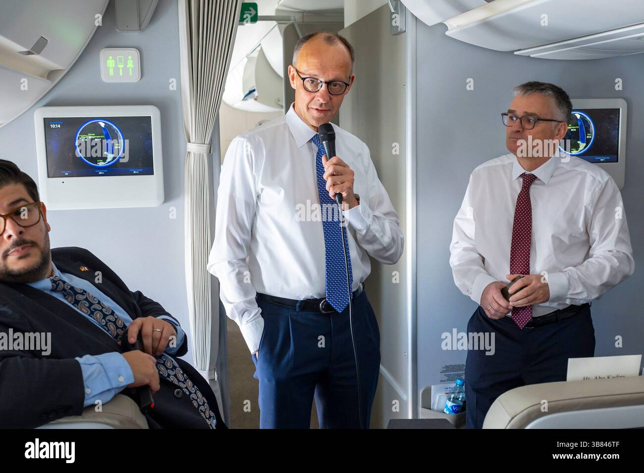 Chancellor Friedrich Merz (CDU) speaks with journalists aboard an