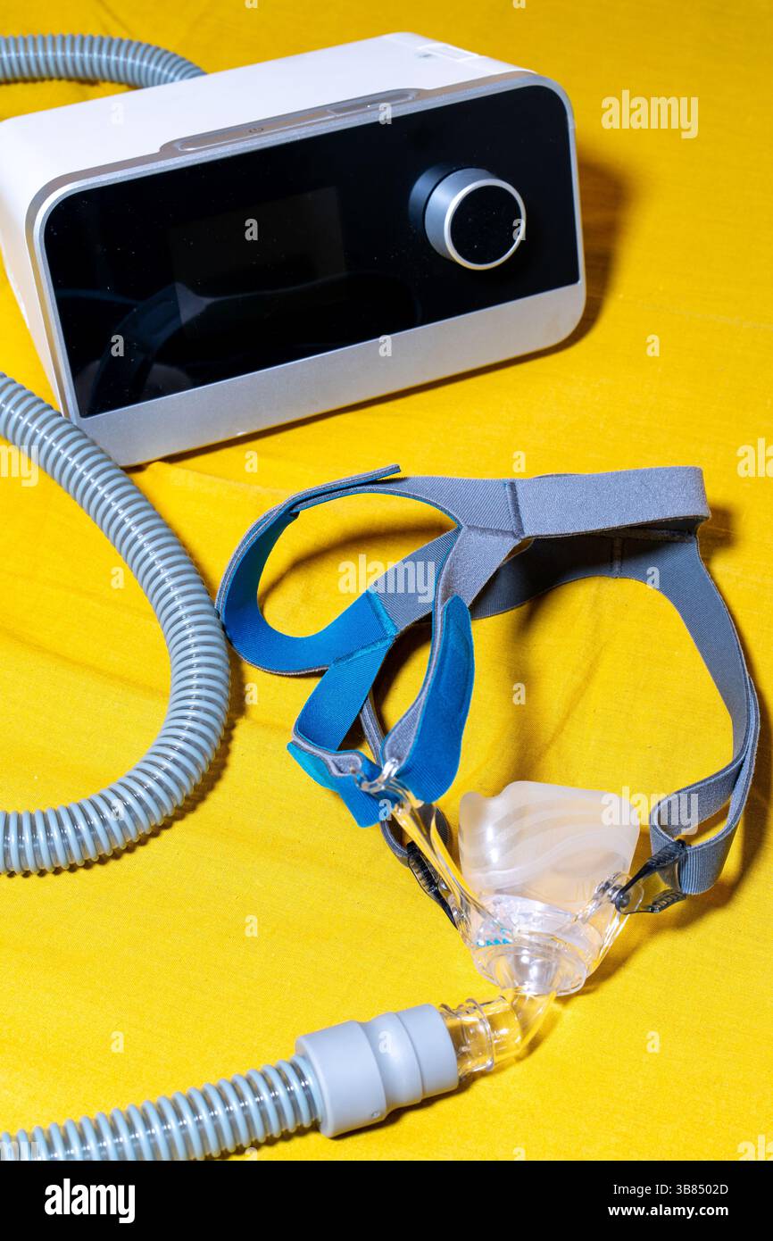 Tube and mask of the Obstructive Sleep Apnea CPAP Machine on a yellow ...