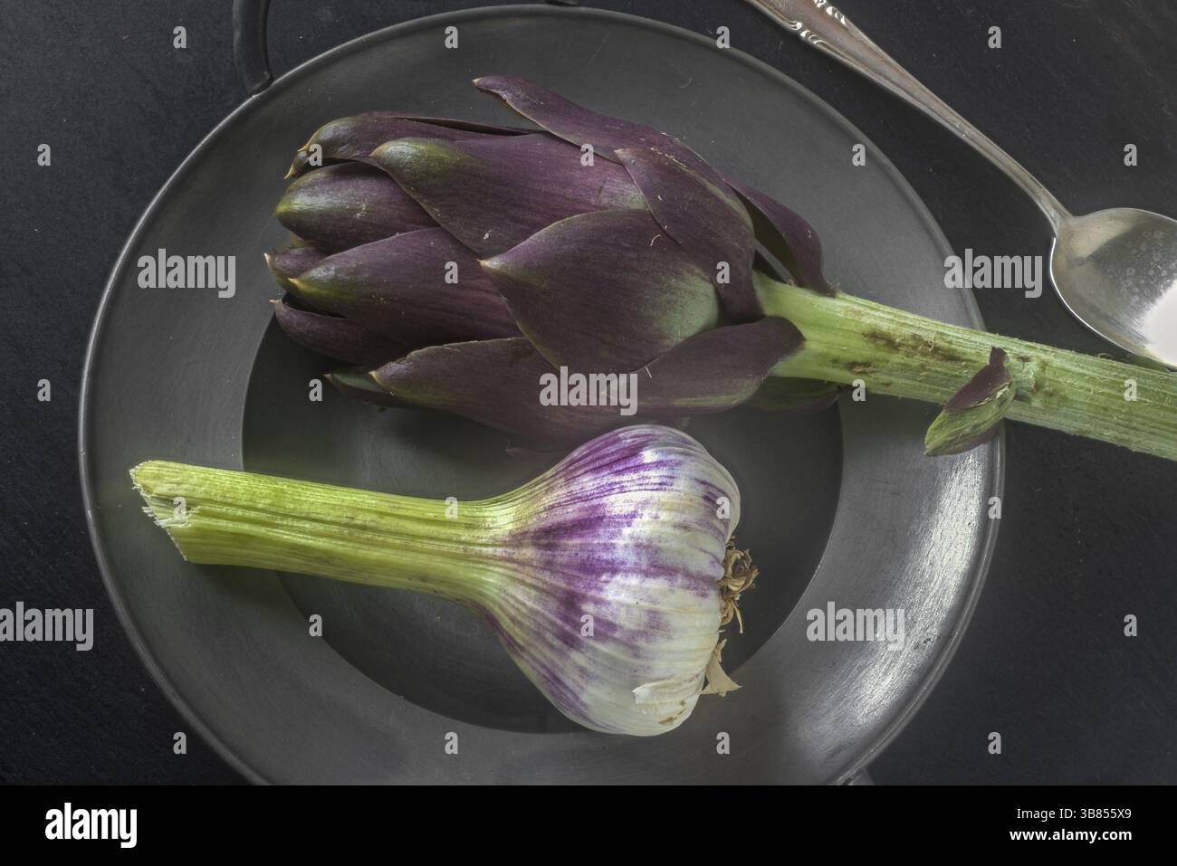 Artichoke in pewter bowl Stock Photo