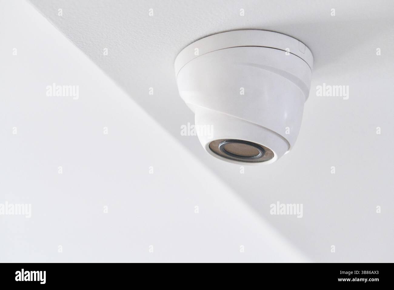 Cctv on white ceiling in modern building Stock Photo