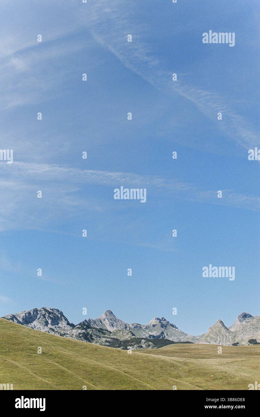 Bright blue sky over mountains and plain Stock Photo - Alamy