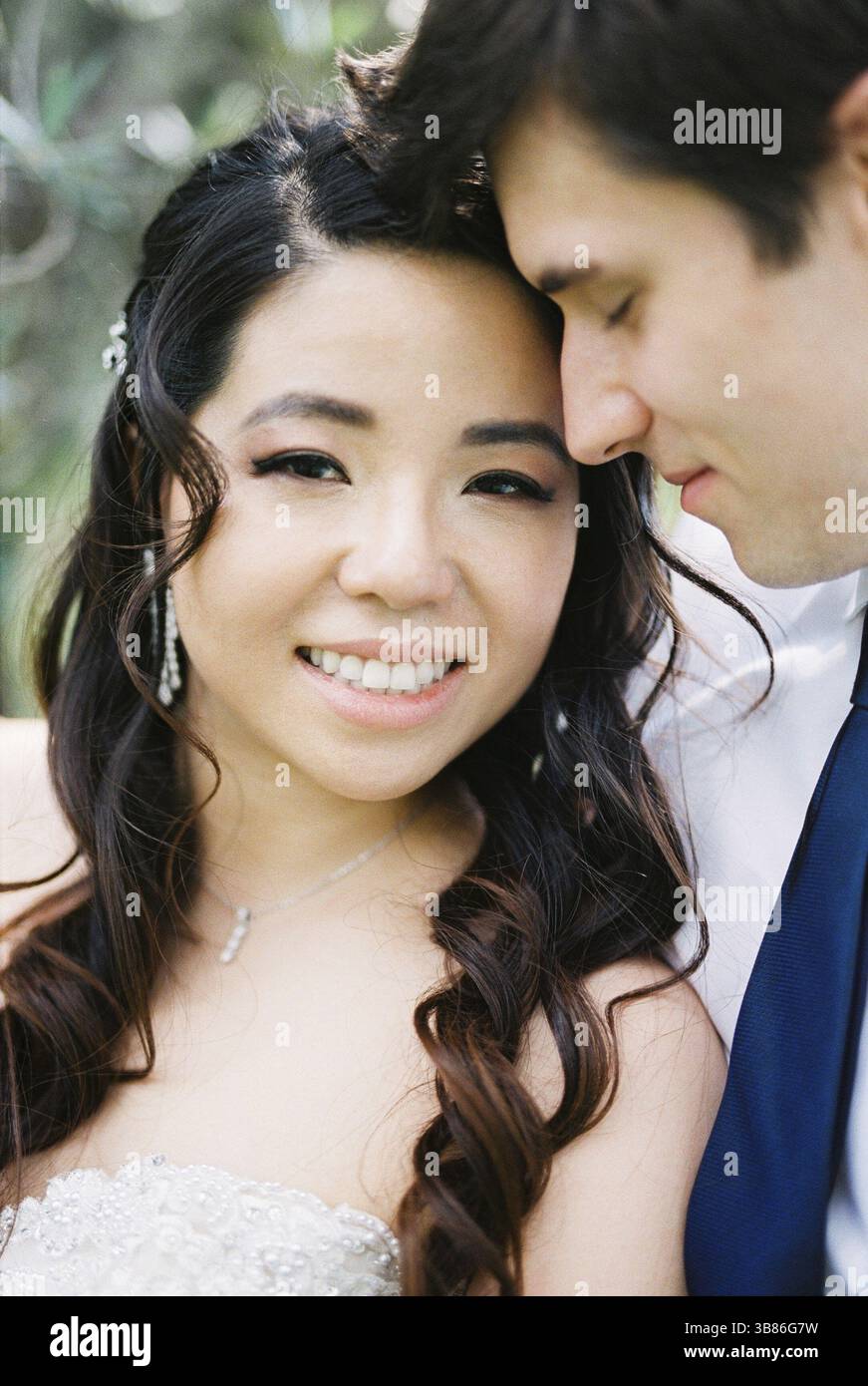 Groom hugs smiling bride. Portrait. Stock Photo