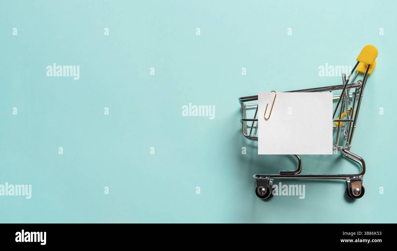 Shopping cart and white paper note list over blue background. Shopping ...