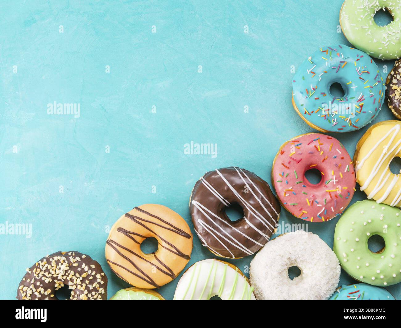 Top view of assorted donuts on blue concrete background with copy space ...