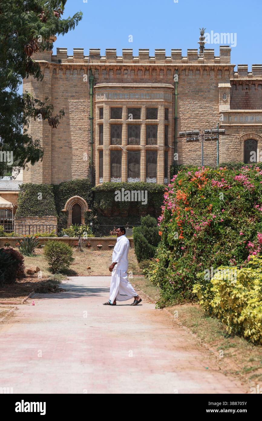 Man walking through the garden of Bengaluru Palace in Bangalore, Karnataka, India Stock Photo