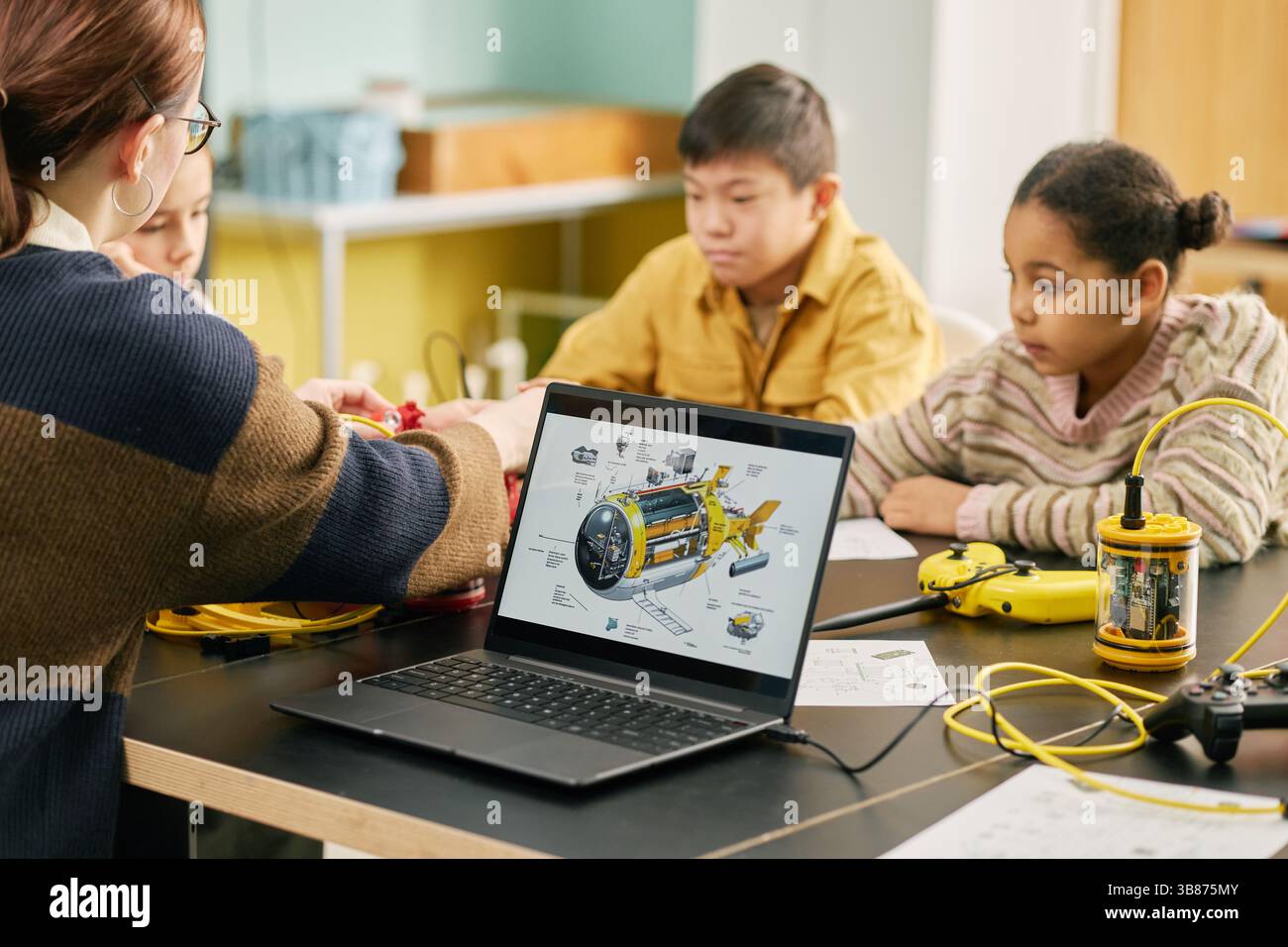 Students participating in interactive science lesson with a teacher ...
