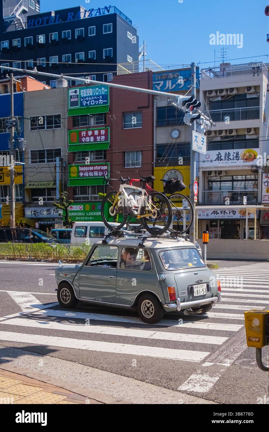 Osaka, Japan - May 3 2024: Classic Mini Car With Bicycles on Roof in an ...