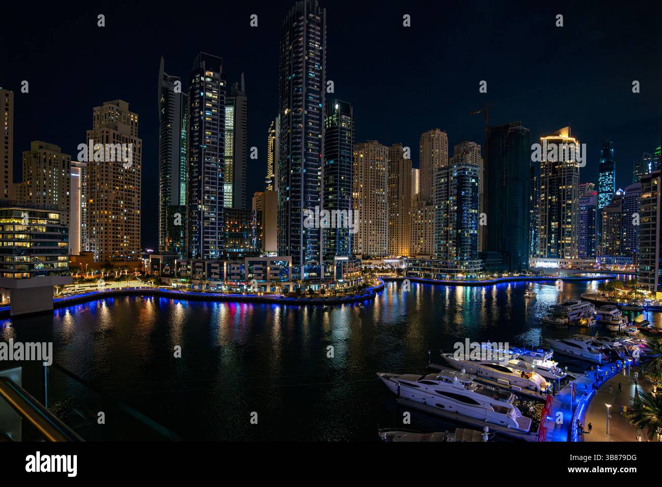 Lights and sky reflected in waters of Dubai Harbour at night Stock Photo