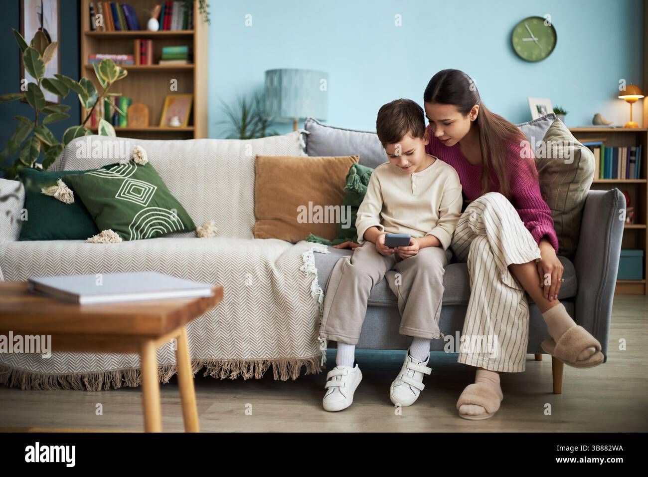 Boy Playing Game On Mobile Phone Stock Photo