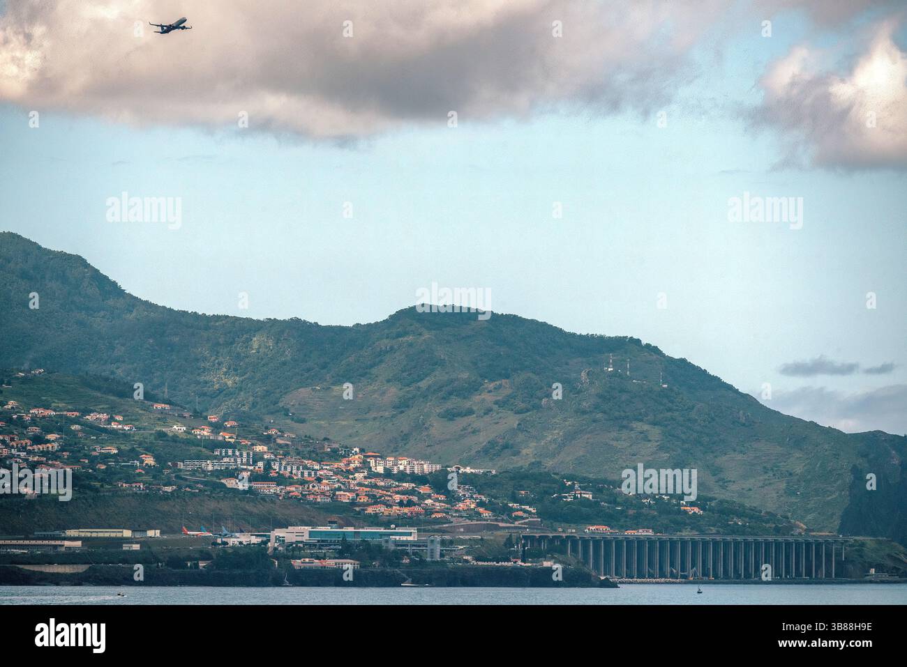 Madeira Funchal Airport (FNC) is known for its challenging runway. One end is built on concrete pillars with nearby steeply climbing terrain Stock Photo