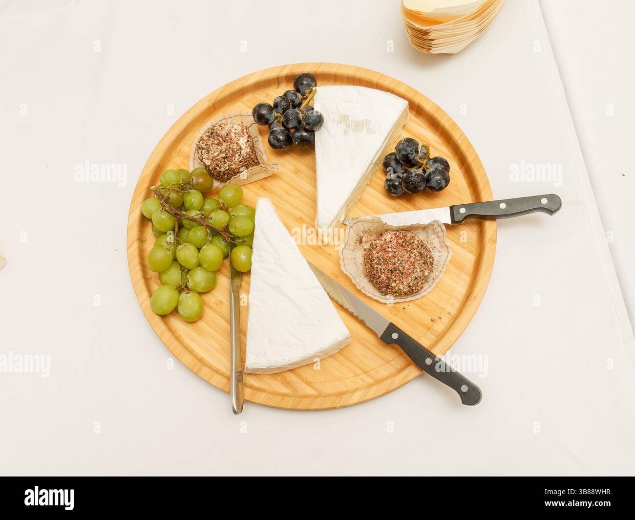 Wedding cheese platter with grapes and a heart-shaped cheese centerpiece, perfect for a romantic and gourmet celebration. Stock Photo