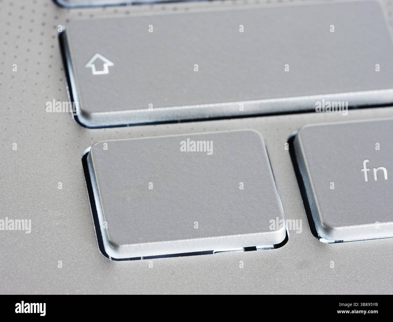 Blank silver button on laptop keyboard. Empty key button with copy space for message. Extreme close up Stock Photo