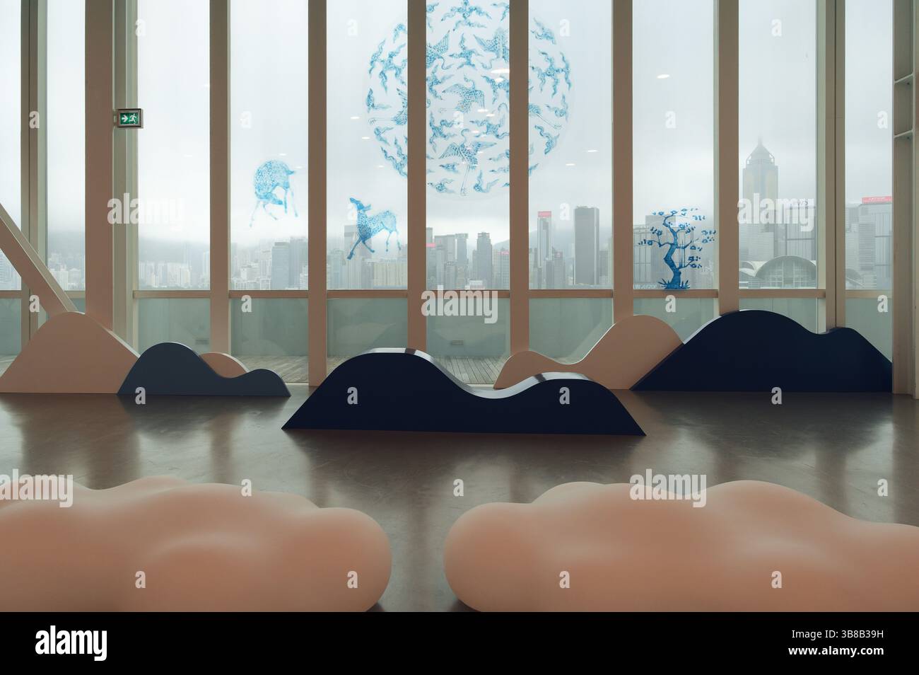 Whimsical blue animal illustrations float against the backdrop of Hong Kong’s skyline in a cloud-themed installation at the HKMoA Stock Photo