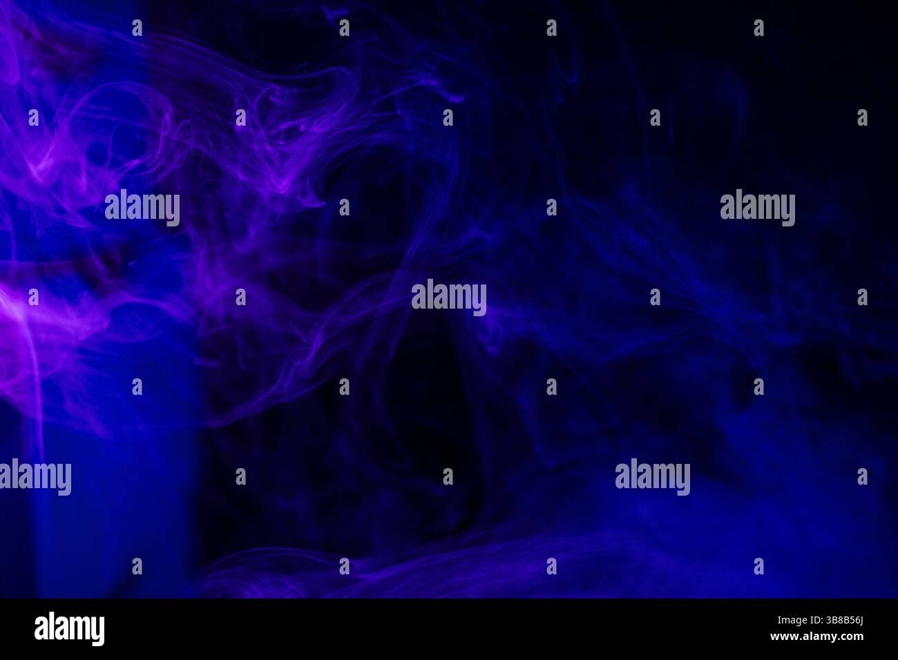 Dark background with purple blue smoke trails Stock Photo
