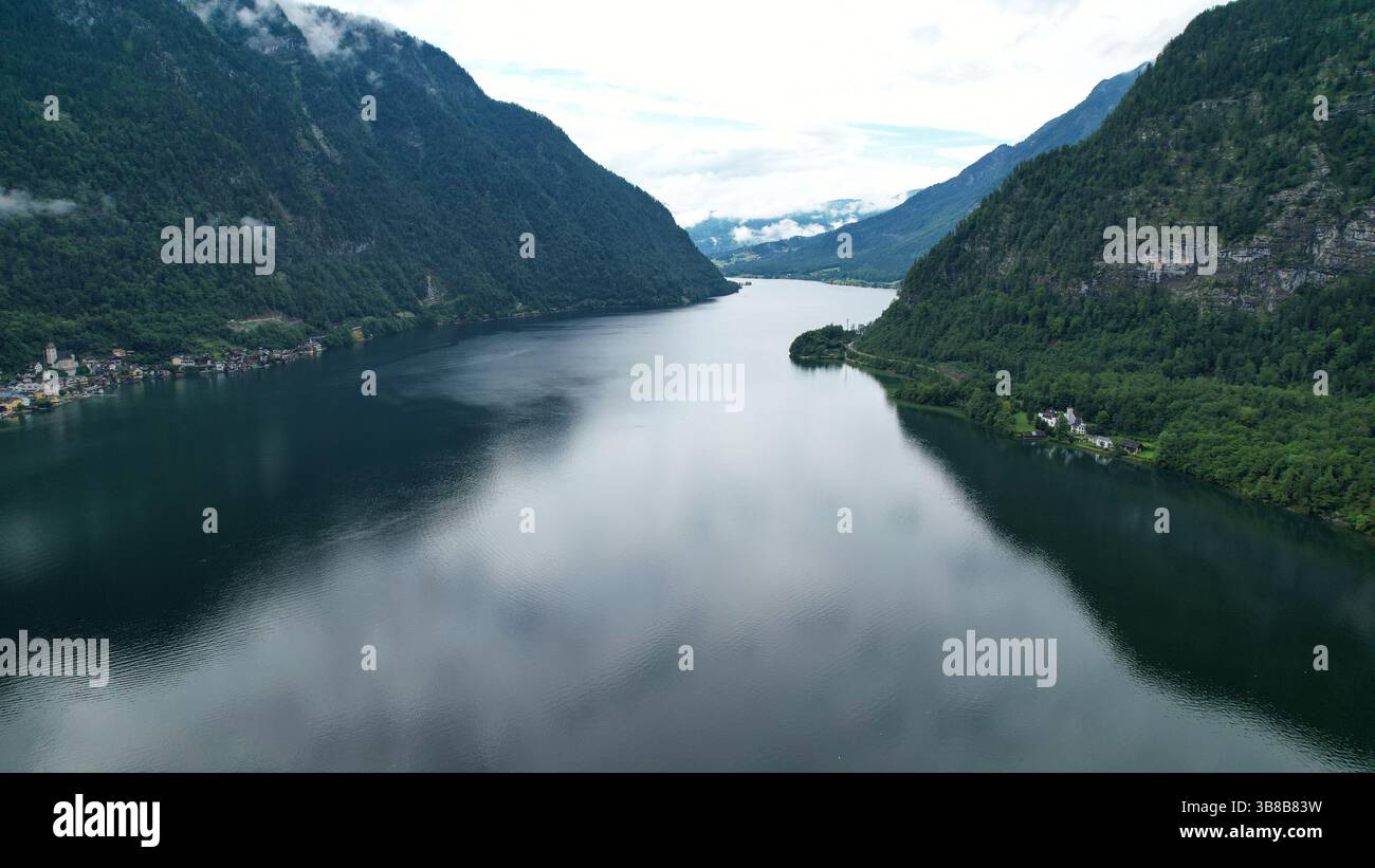 Peaceful Alpine Lake Surrounded by Majestic Mountains and Village Charm Stock Photo