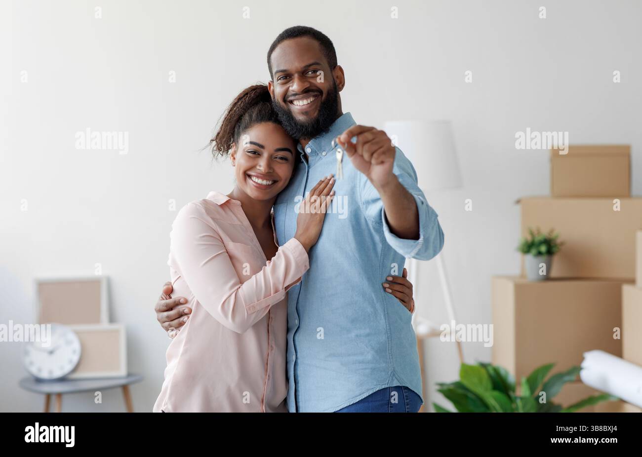 Happy smiling young african american loving family hugging in new home ...
