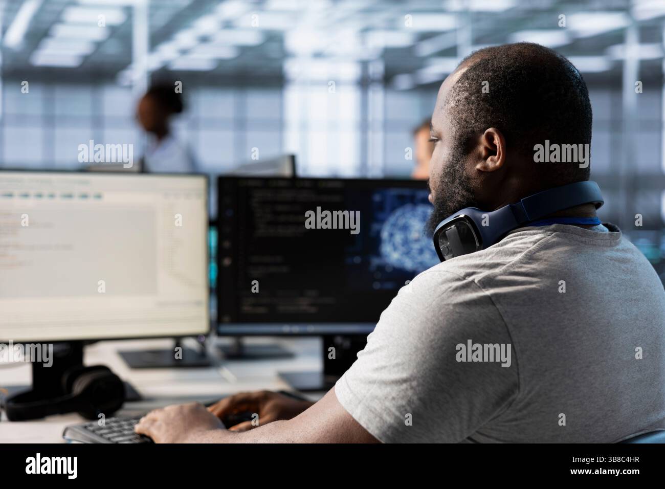 Computer scientist using artificial intelligence technology to optimize data center performance. African american IT expert in server farm using AI tech to accurately forecast potential issues Stock Photo