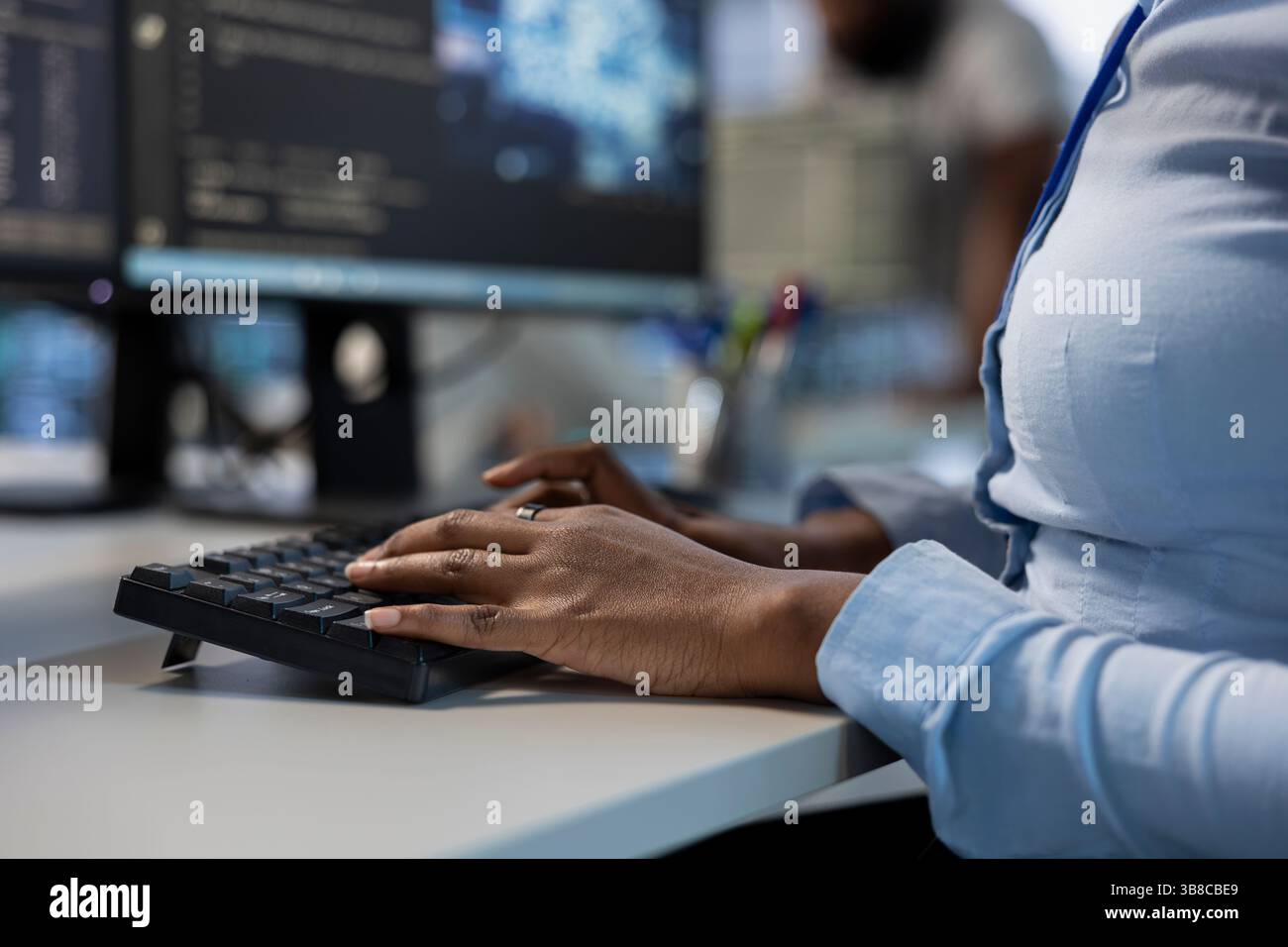 Engineer in data center typing on keyboard, optimizing IT ...
