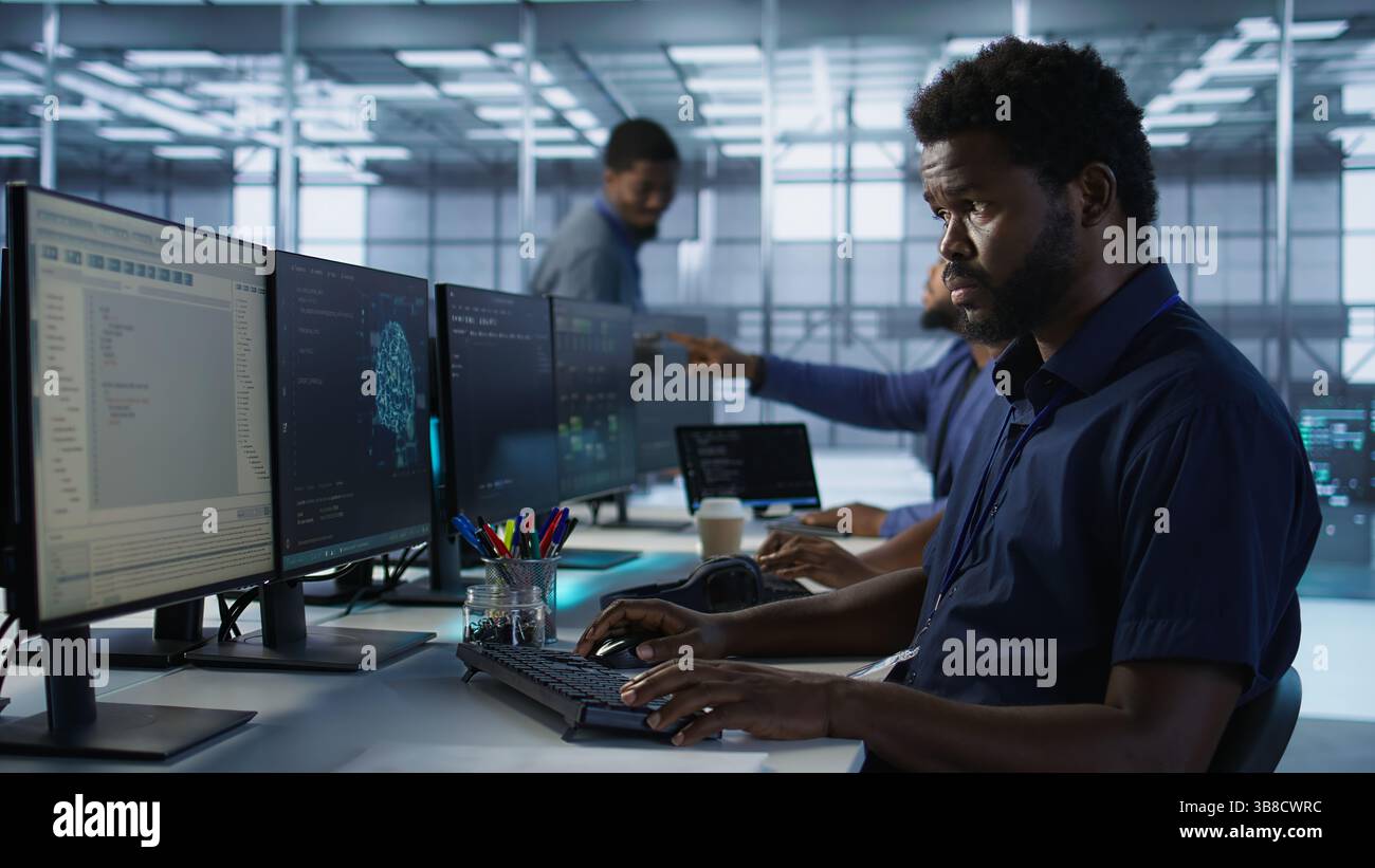 Developers in data center workspace implementing AI predictive maintenance systems. Admin in server hub office using artificial intelligence machine learning tech to identify hardware failures Stock Photo