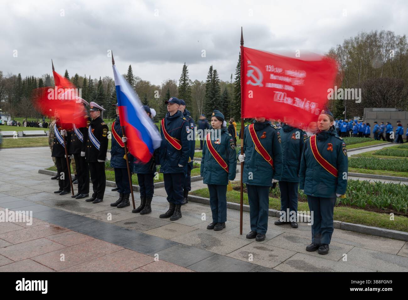 Cadets hold Soviet and Russian flags while participating in the “Be ...