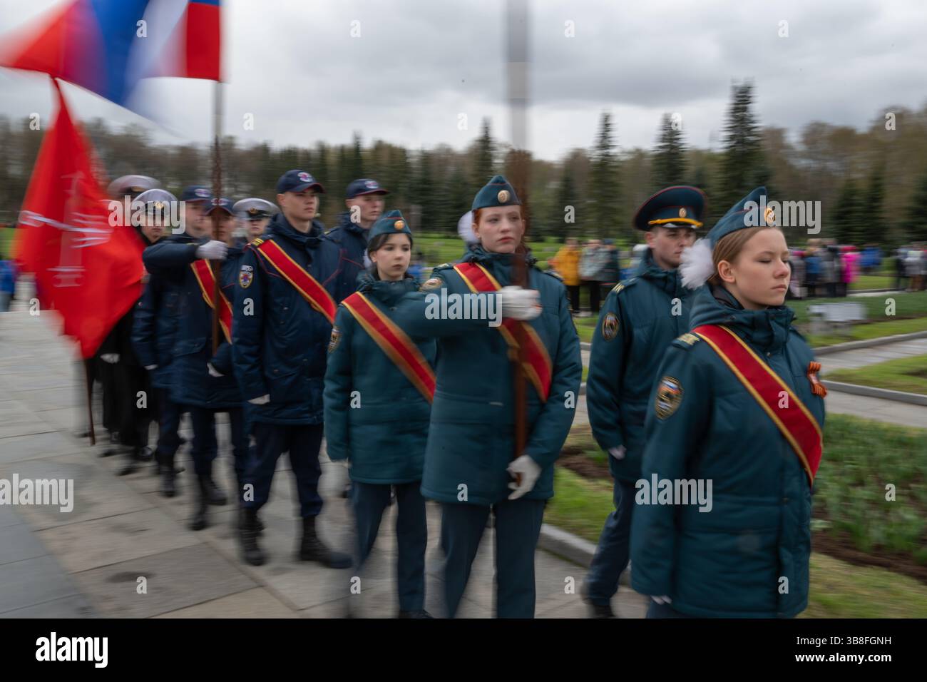 Cadets hold Soviet and Russian flags while participating in the “Be ...