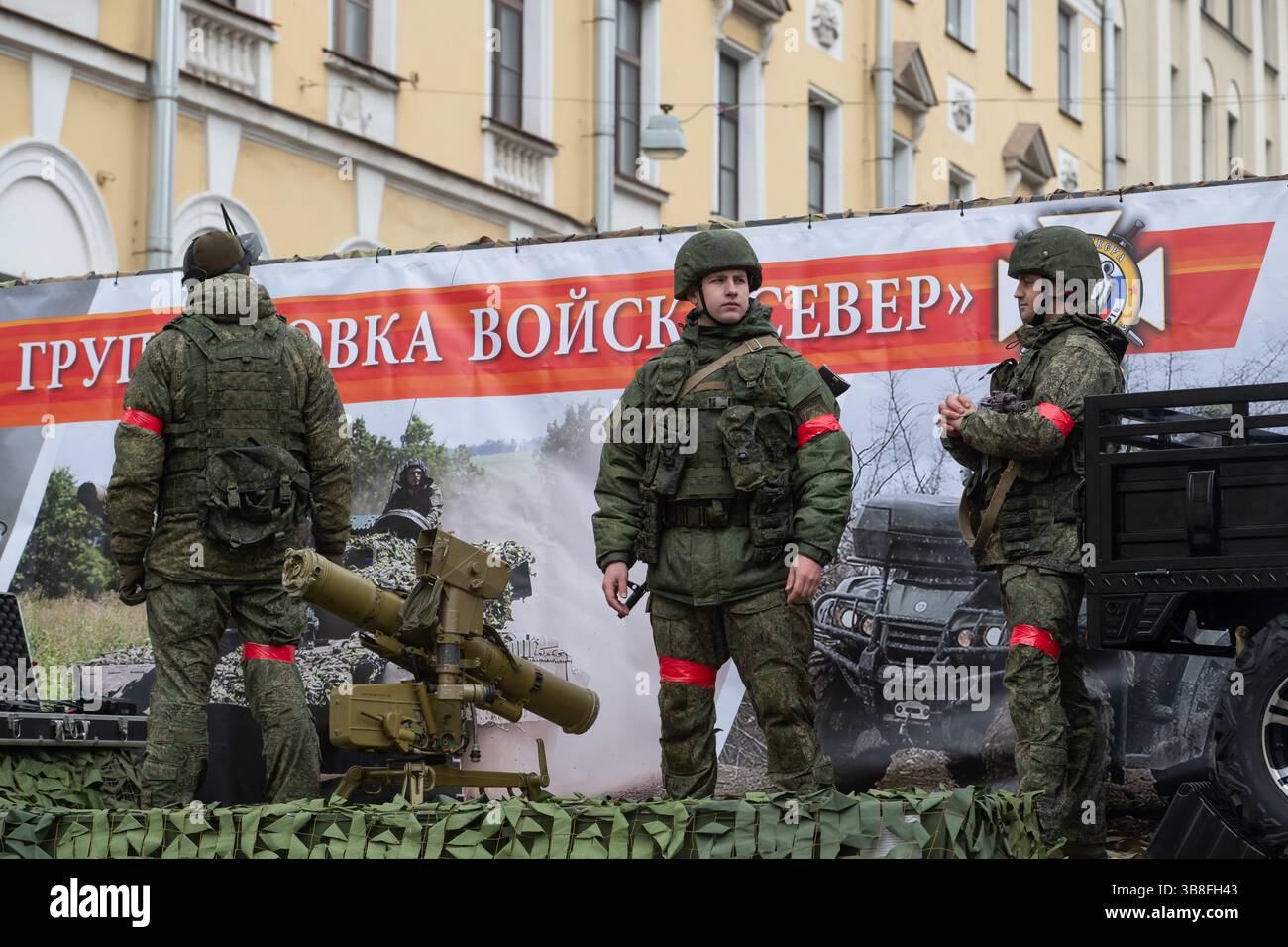 Service members of the Russian Armed Forces stand against the backdrop ...