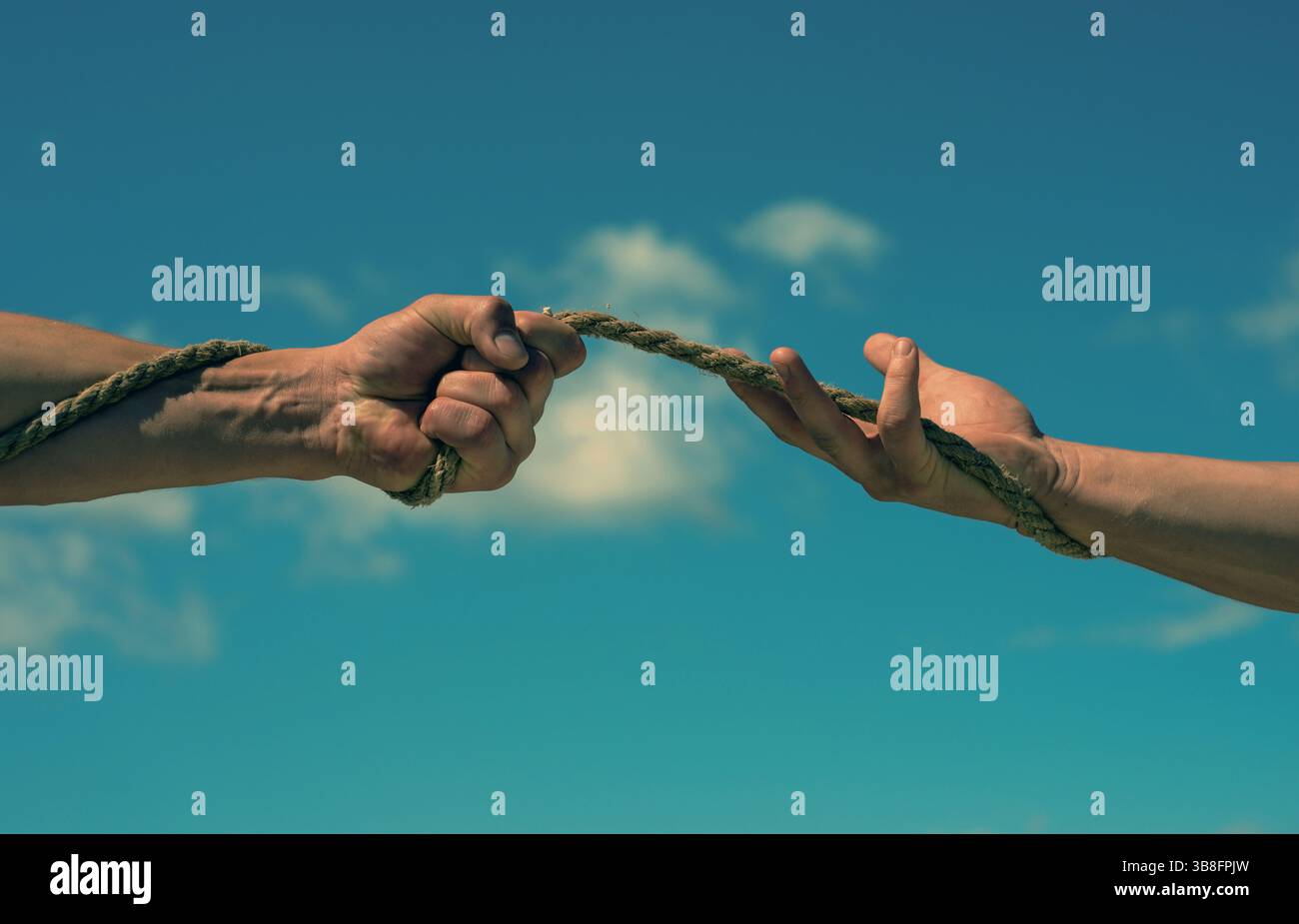 Two hands pulling rope hi-res stock photography and images - Alamy