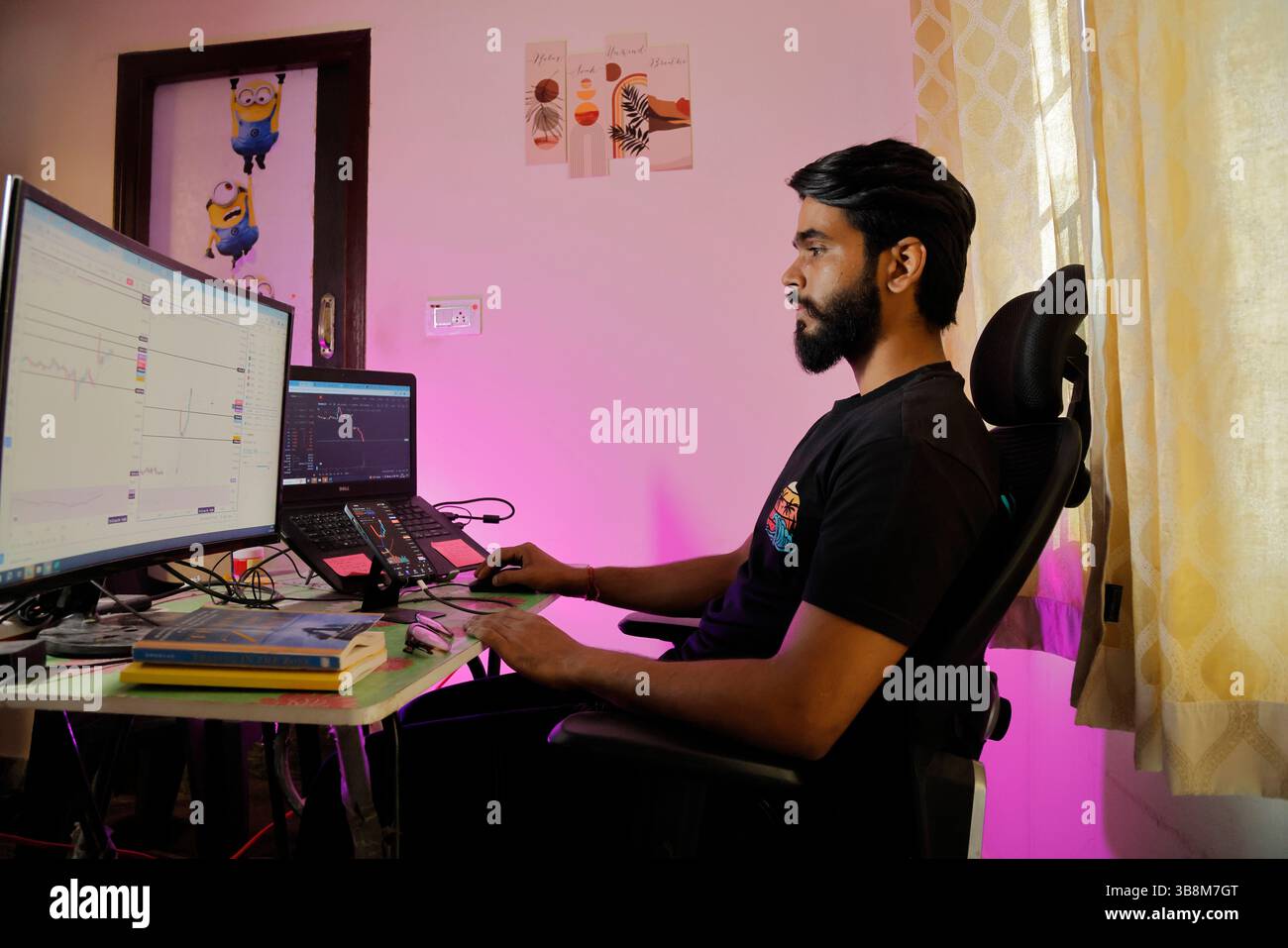 January 12, 2024, Bengaluru: 12Jan2024 - Bengaluru- INDIA..Love Pulkit at his Home Stock Trading Setup desk.He is a budding Stock market options trader. Initially after having lost heavily in the stock market options trades, he has started recovering and making steady profits in options trading. (Credit Image: © Subhash Sharma/ZUMA Press Wire) Stock Photo
