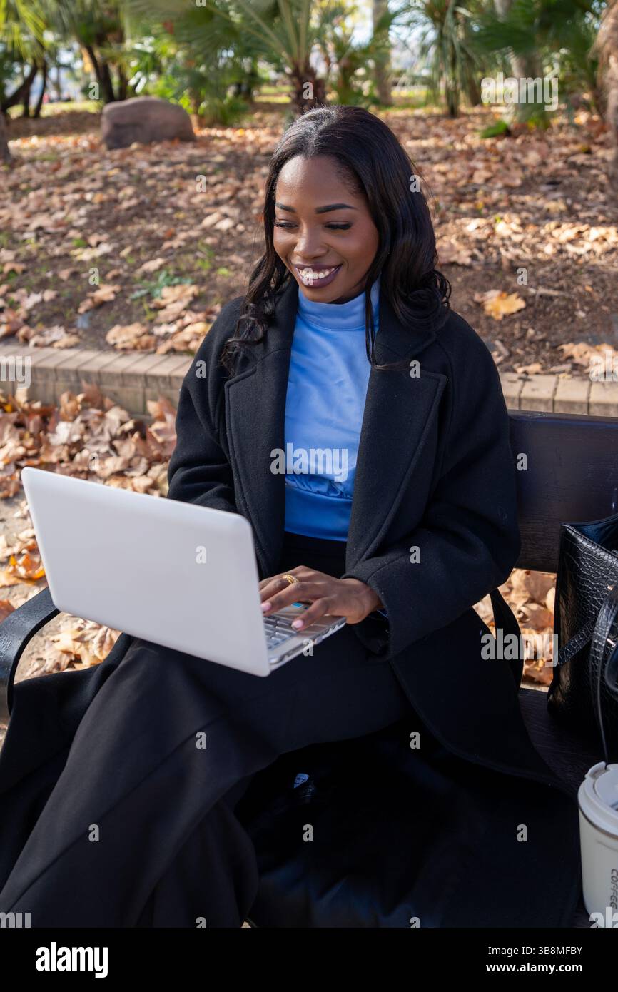 Young manager enjoying working outdoors on a beautiful autumn day Stock Photo