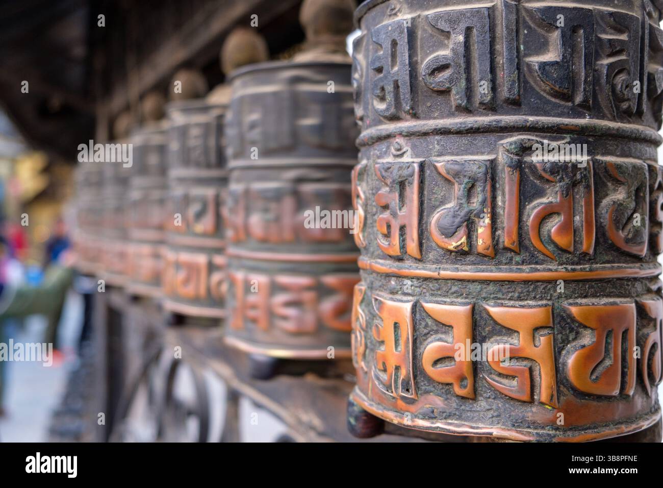 Buddhist prayer wheels, inscribed with mantras, are spun to accumulate wisdom and merit. Stock Photo